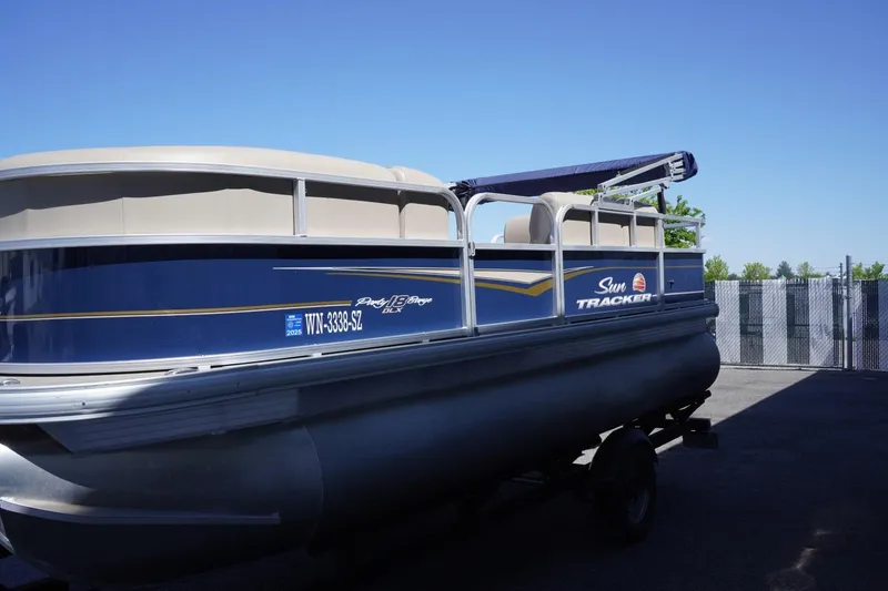 Slide: The Image of 2022 Sun Tracker Party Barge 18 DLX pontoon boat parked outdoors. - 6