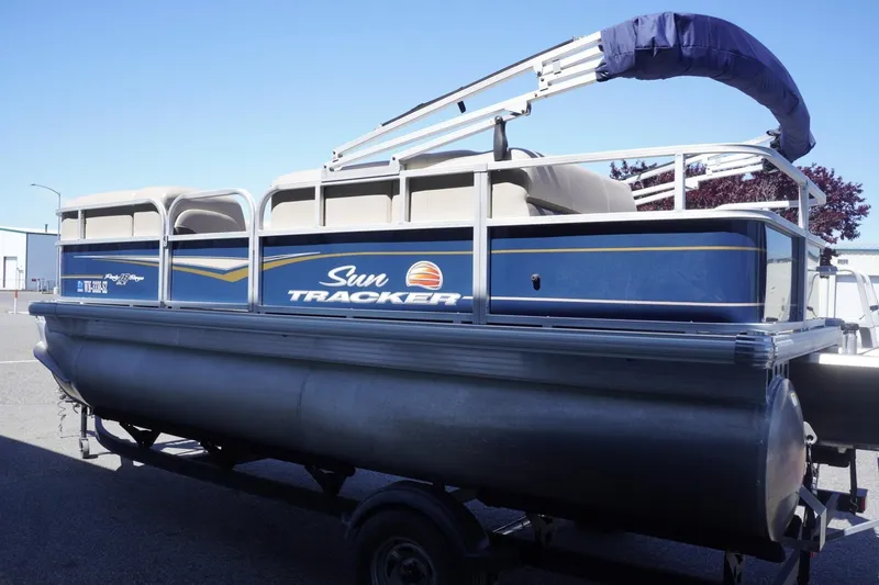 Slide: The Image of 2022 Sun Tracker Party Barge 18 DLX pontoon boat on trailer, side view. - 7