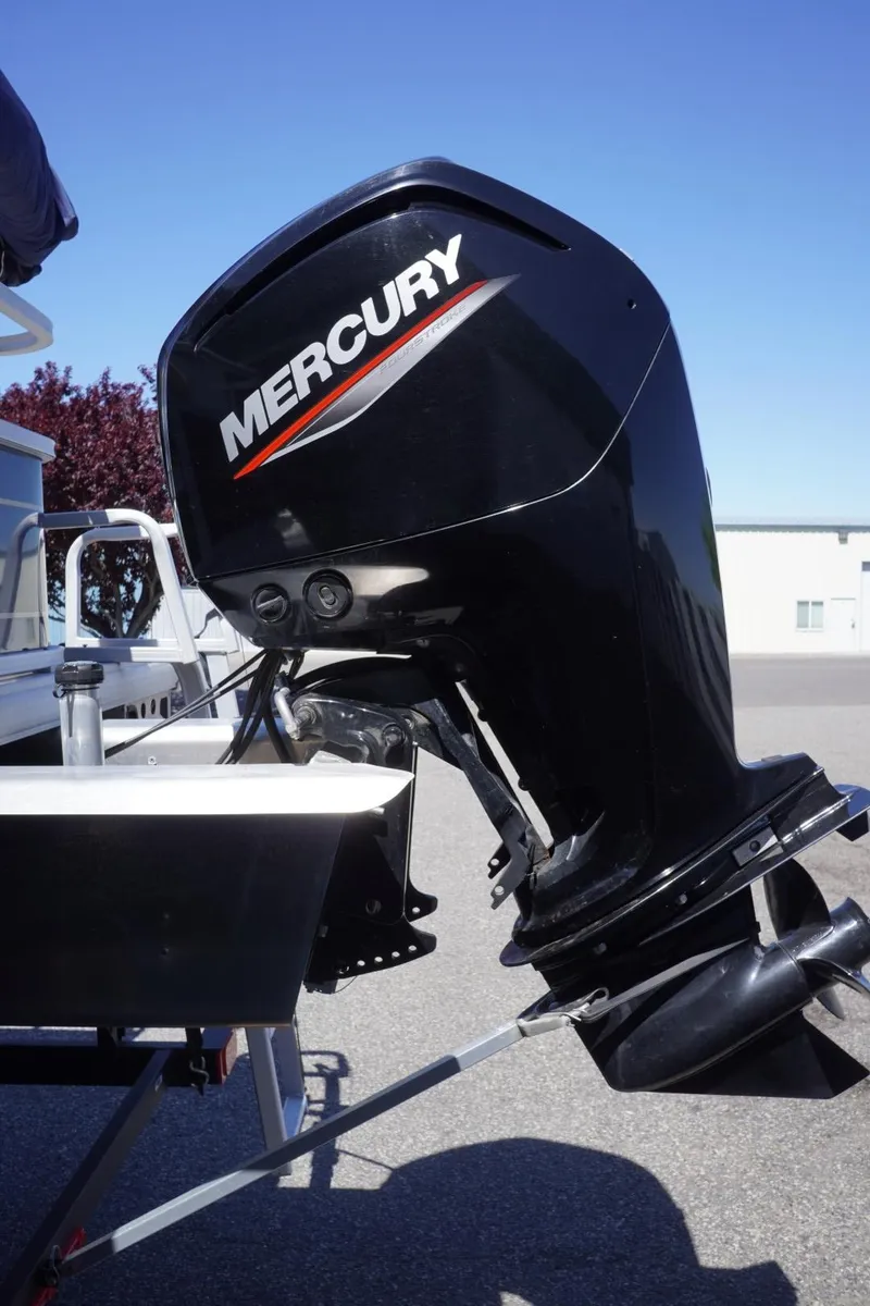 Slide: The Image of 2022 Sun Tracker Party Barge 18 DLX with Mercury outboard motor, parked outdoors. - 9