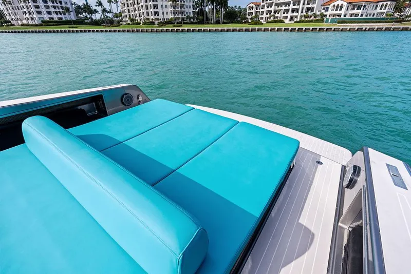 Slide: The Image of Luxury VanDutch 55 yacht with turquoise seating, cruising near waterfront buildings. - 22