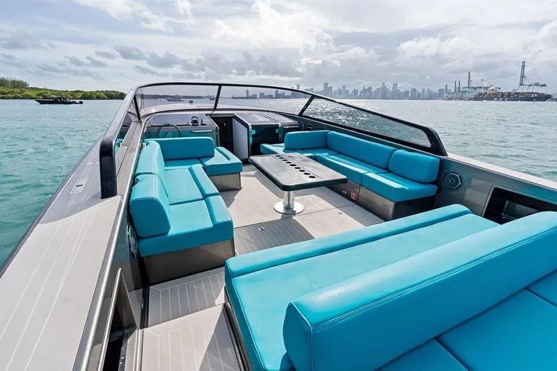 Slide: The Image of VanDutch 55 yacht, 2015 model, with turquoise seating, cruising on open water. - 23