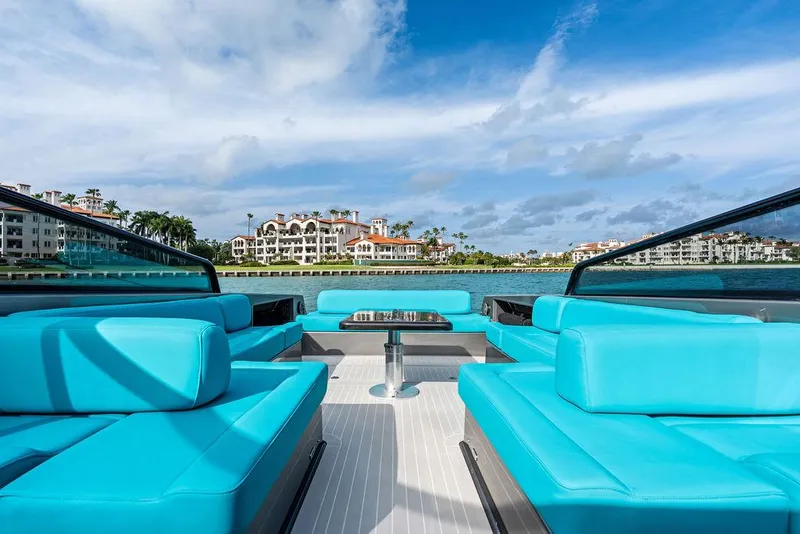 Slide: The Image of Luxurious 2015 VanDutch 55 yacht with turquoise seating, cruising near waterfront properties. - 26