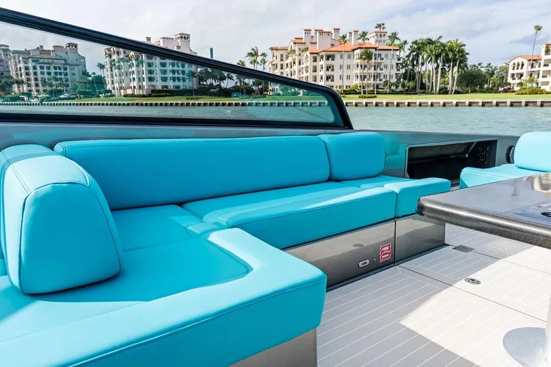 Slide: The Image of Luxurious 2015 VanDutch 55 yacht with turquoise seating, docked near waterfront buildings. - 28