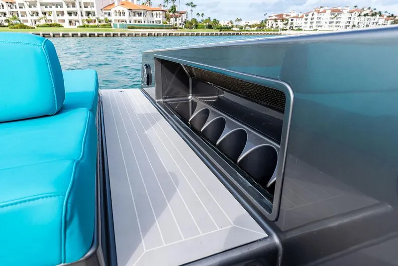 Slide: The Image of 2015 VanDutch 55 yacht with turquoise seating and sleek design near waterfront buildings. - 32