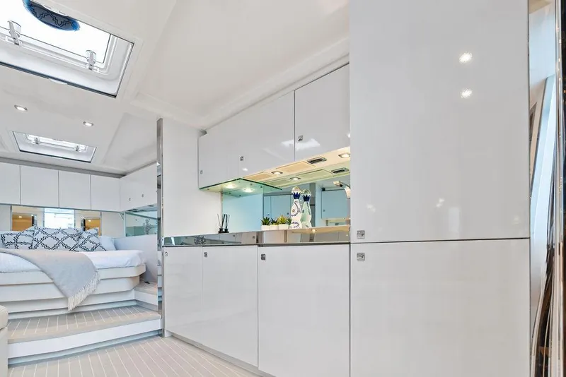 Slide: The Image of Luxurious interior of a 2015 VanDutch 55 yacht with modern white cabinetry and cozy bedroom. - 42