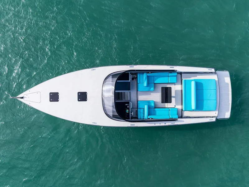 Slide: The Image of Aerial view of 2015 VanDutch 55 yacht with turquoise seating on open water. - 7