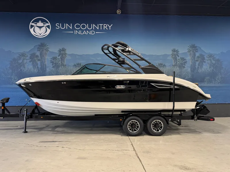 The Image of 2026 Sea Ray SDX 250 Surf boat on trailer at Sun Country Inland showroom. - 1