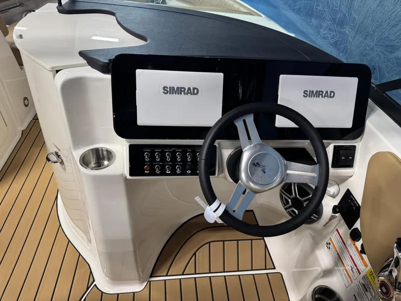 Slide: The Image of 2026 Sea Ray SDX 250 Surf boat dashboard with Simrad displays and steering wheel. - 15