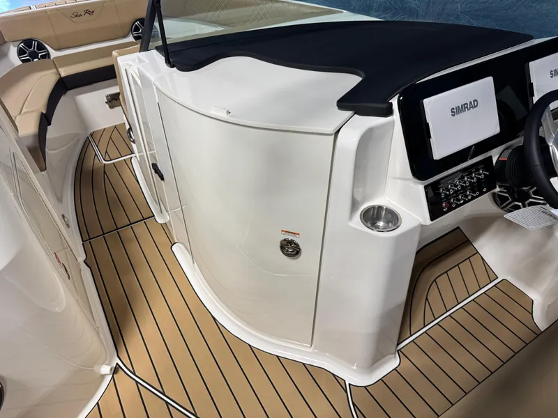 Slide: The Image of 2026 Sea Ray SDX 250 Surf boat interior with Simrad electronics and teak flooring. - 16