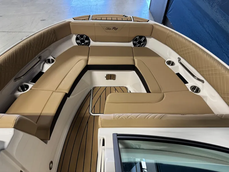 Slide: The Image of 2026 Sea Ray SDX 250 Surf boat interior with tan seating and cup holders. - 18