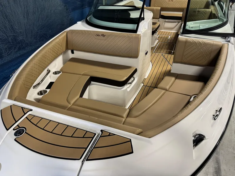 Slide: The Image of 2026 Sea Ray SDX 250 Surf boat interior with tan seating and sleek design. - 19
