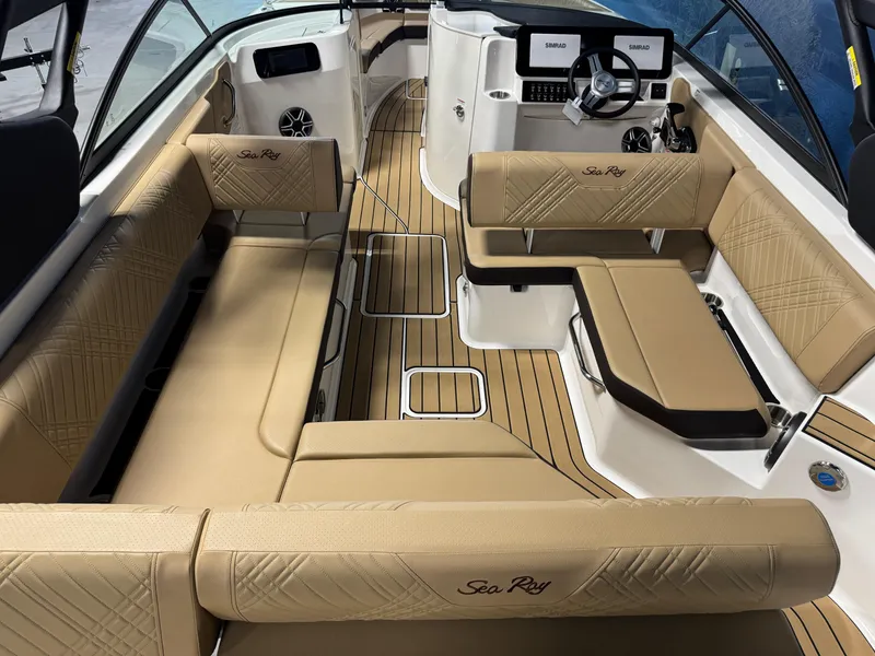 Slide: The Image of 2026 Sea Ray SDX 250 Surf boat interior with tan seating and modern dashboard. - 6