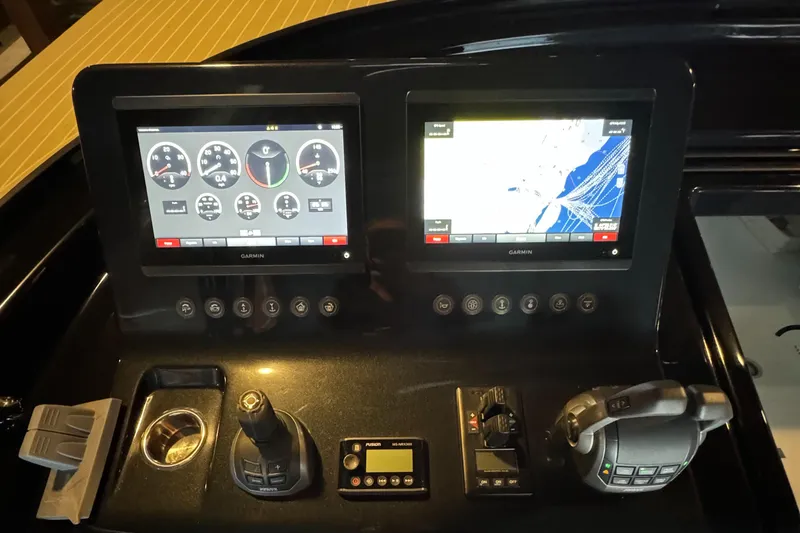 Slide: The Image of Control panel of a 2019 VanDutch 40 yacht with navigation screens and controls. - 12
