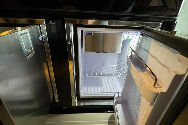 Slide: The Image of Open refrigerator inside 2019 VanDutch 40 yacht, showcasing sleek interior design. - 16