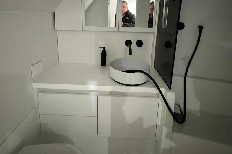 Slide: The Image of Modern bathroom interior of 2019 VanDutch 40 yacht with sleek white design and black fixtures. - 22