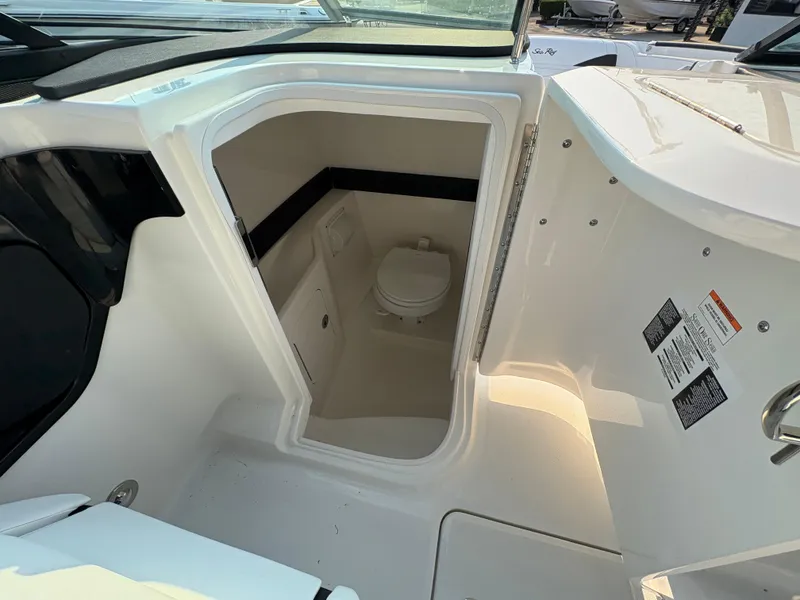 Slide: The Image of 2026 Sea Ray SLX 260 boat interior with compact bathroom. - 10