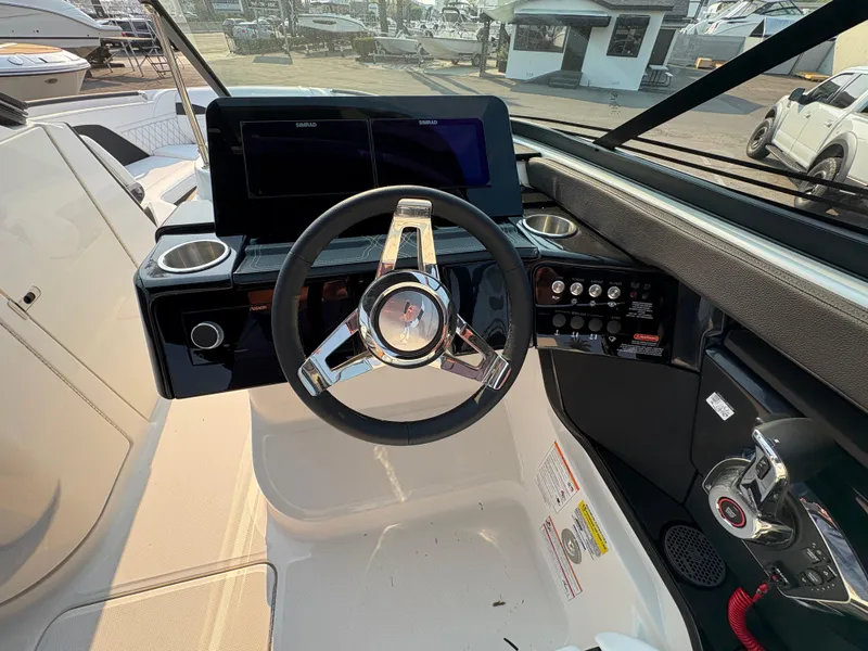 Slide: The Image of 2026 Sea Ray SLX 260 boat dashboard with steering wheel and control panel. - 11