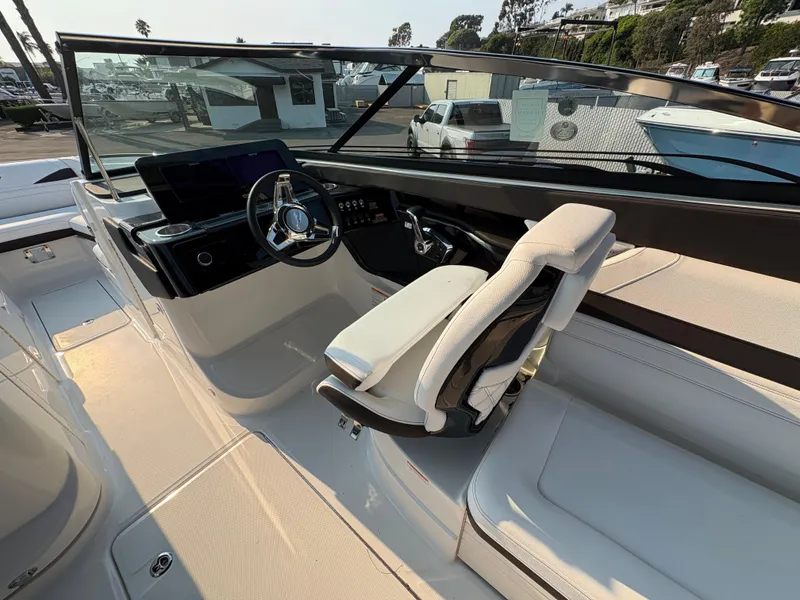 Slide: The Image of 2026 Sea Ray SLX 260 boat cockpit with modern steering and seating. - 7