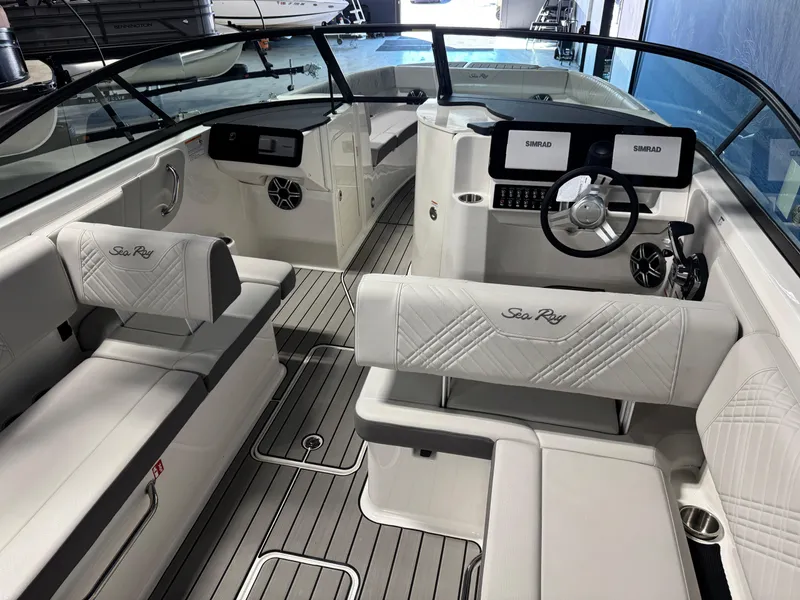Slide: The Image of 2026 Sea Ray SDX 270 boat interior with modern dashboard and luxurious seating. - 11