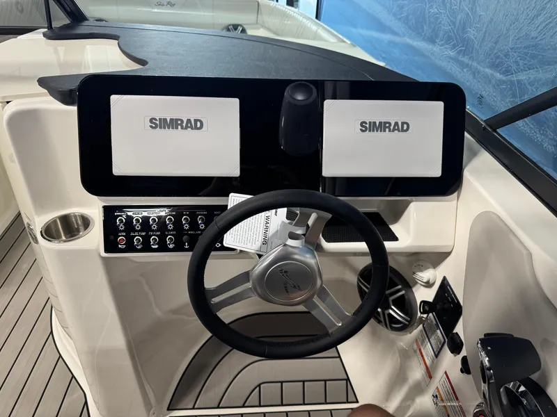 Slide: The Image of 2026 Sea Ray SDX 270 helm with dual Simrad displays and modern controls. - 14