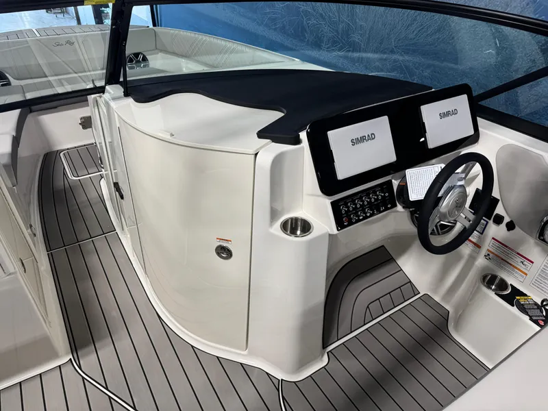 Slide: The Image of 2026 Sea Ray SDX 270 boat cockpit with dual Simrad displays and sleek design. - 16