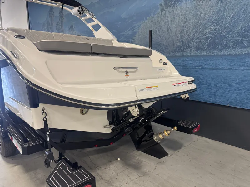 Slide: The Image of 2026 Sea Ray SDX 270 boat on trailer, rear view in showroom setting. - 4