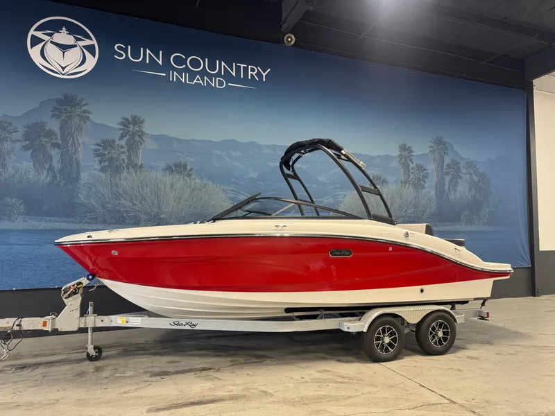 The Image of 2026 Sea Ray SPX 210 boat in showroom, red and white design, on trailer. - 1