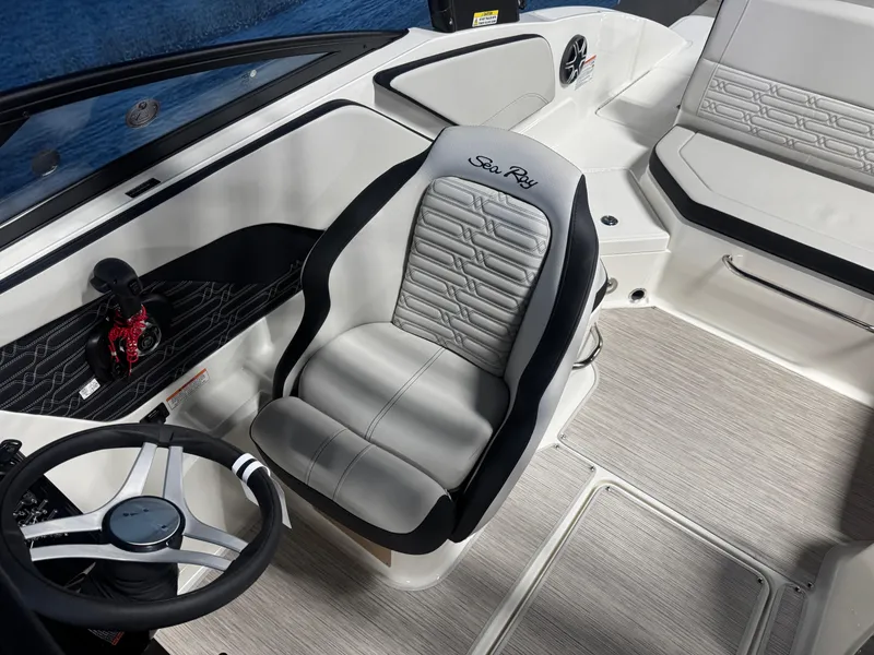 Slide: The Image of 2026 Sea Ray SPX 210 boat interior with sleek steering and comfortable seating. - 13