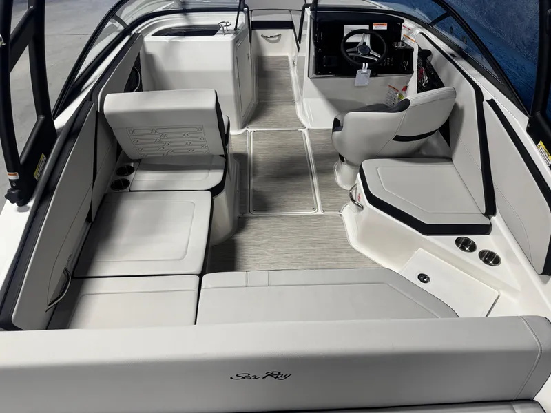 Slide: The Image of Interior of a 2026 Sea Ray SPX 210 boat with modern seating and steering console. - 7