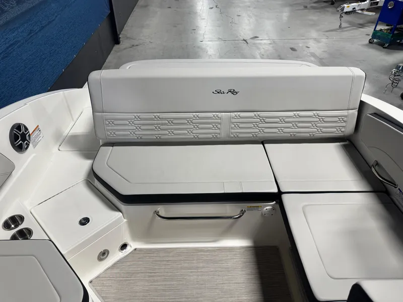 Slide: The Image of 2026 Sea Ray SPX 210 boat interior with white cushioned seating and speaker. - 8