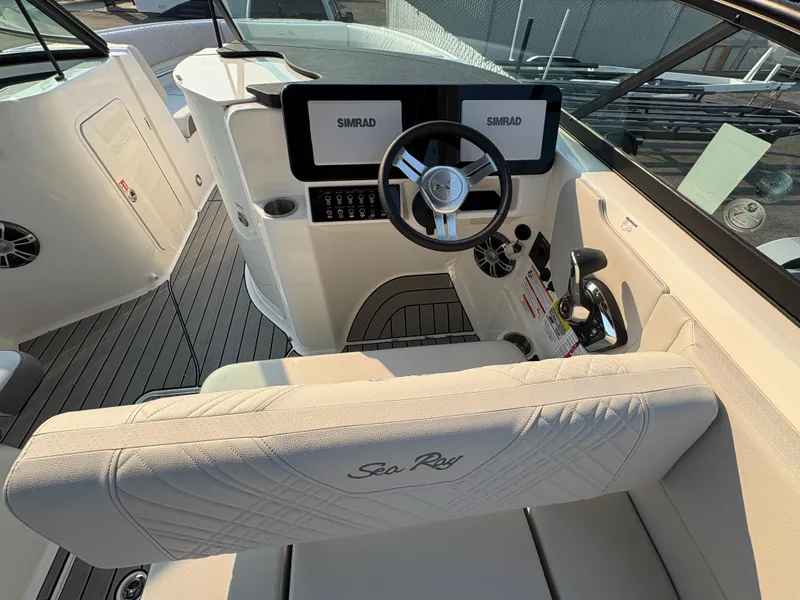 Slide: The Image of 2026 Sea Ray SDX 250 boat cockpit with Simrad display and steering wheel. - 3