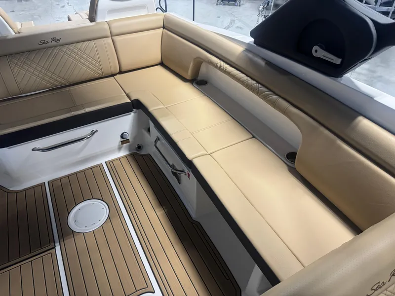 Slide: The Image of Luxurious seating area on 2026 Sea Ray SDX 290 boat with tan upholstery and wood flooring. - 10