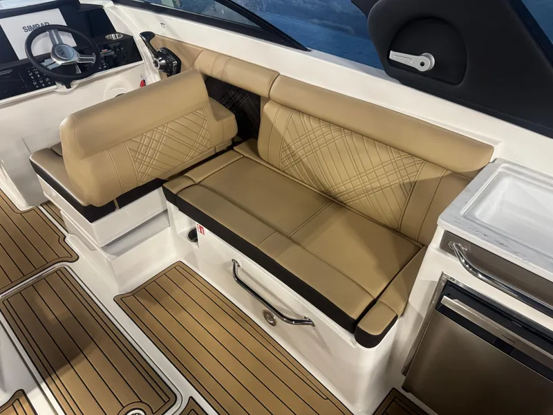 Slide: The Image of 2026 Sea Ray SDX 290 interior with tan seating and modern helm design. - 11