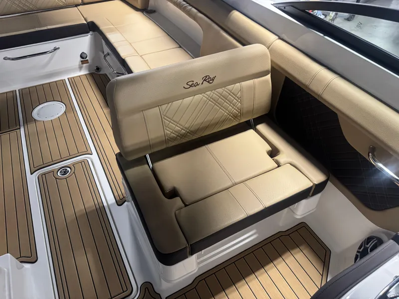 Slide: The Image of 2026 Sea Ray SDX 290 interior with tan leather seating and wood-style flooring. - 12