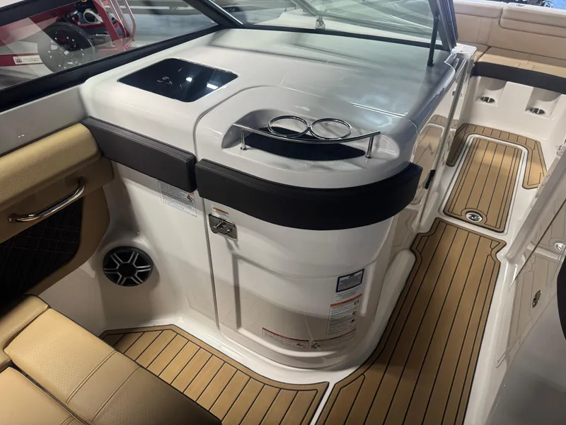 Slide: The Image of Interior of 2026 Sea Ray SDX 290 boat with tan seating and wood-style flooring. - 14