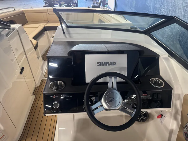 Slide: The Image of 2026 Sea Ray SDX 290 helm with Simrad display and modern steering wheel. - 16