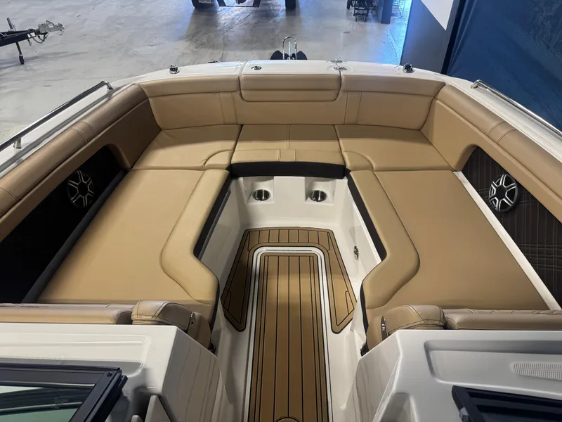 Slide: The Image of 2026 Sea Ray SDX 290 boat interior with tan seating and wood accents. - 17
