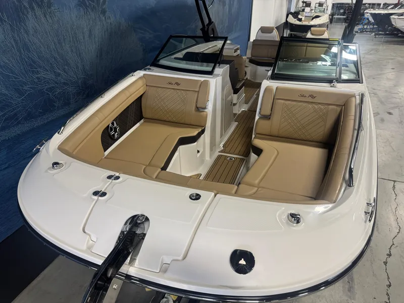 Slide: The Image of 2026 Sea Ray SDX 290 boat with tan seating and sleek design in showroom. - 18