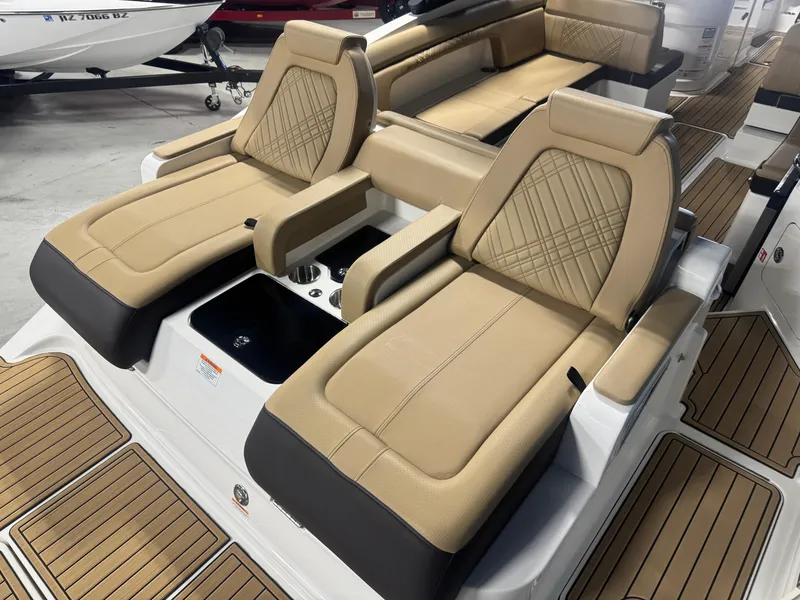Slide: The Image of 2026 Sea Ray SDX 290 boat with luxurious tan seating and sleek design. - 6