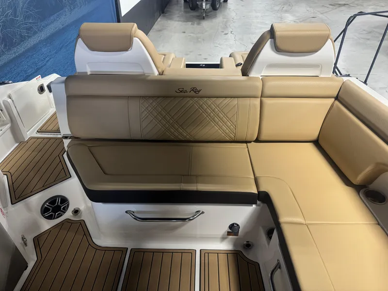 Slide: The Image of Luxurious seating on 2026 Sea Ray SDX 290 boat with tan upholstery and wood accents. - 9