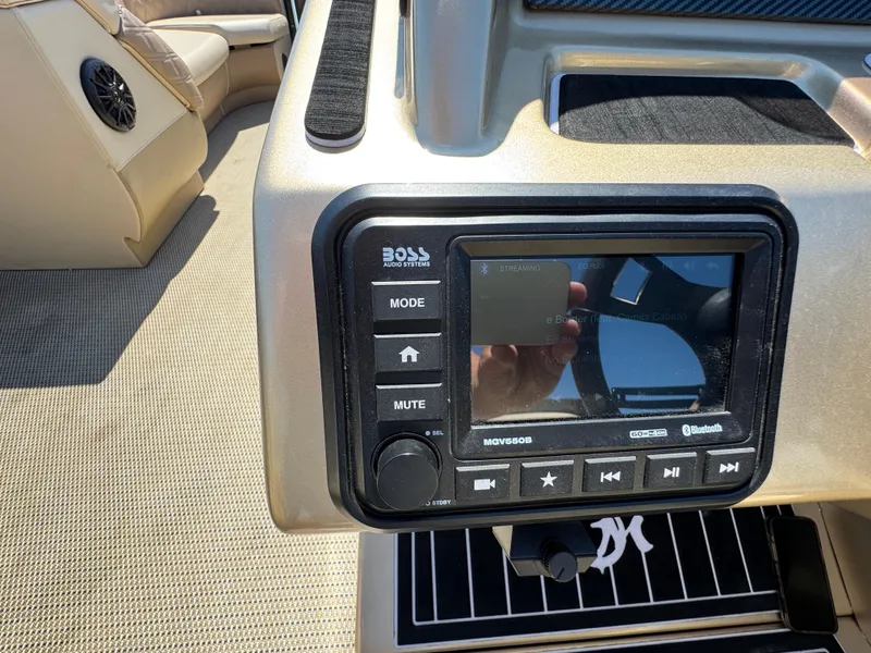 Slide: The Image of Control panel of a 2023 Massimo Marine P24 boat with audio system and Bluetooth connectivity. - 18