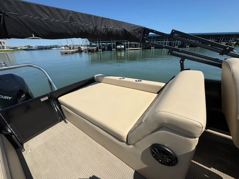 Slide: The Image of 2023 Massimo Marine P24 boat with beige seating, docked by a serene waterfront. - 25