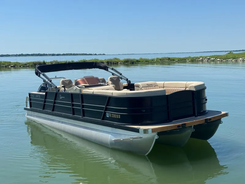Slide: The Image of 2023 Massimo Marine P24 pontoon boat on calm water, featuring sleek design and comfortable seating. - 3