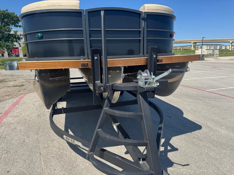 Slide: The Image of 2023 Massimo Marine P24 pontoon boat on trailer in parking lot. - 9