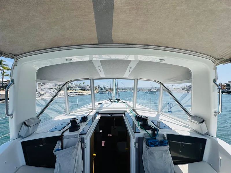 Slide: The Image of Beneteau Oceanis 41.1 sailboat cockpit view, 2020 model, with marina in the background. - 11