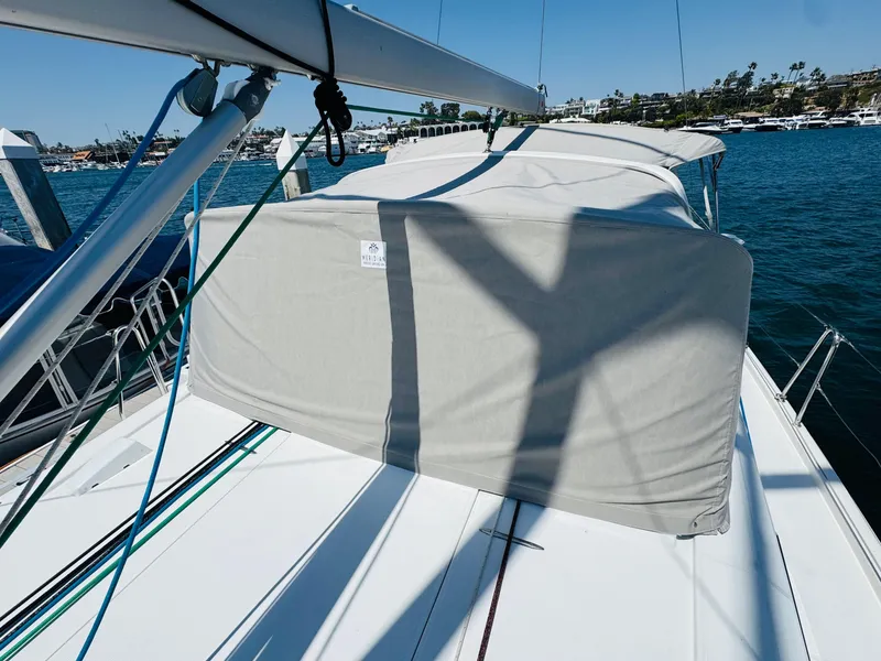 Slide: The Image of Beneteau Oceanis 41.1 sailboat deck with cover, docked in a marina, 2020 model. - 13