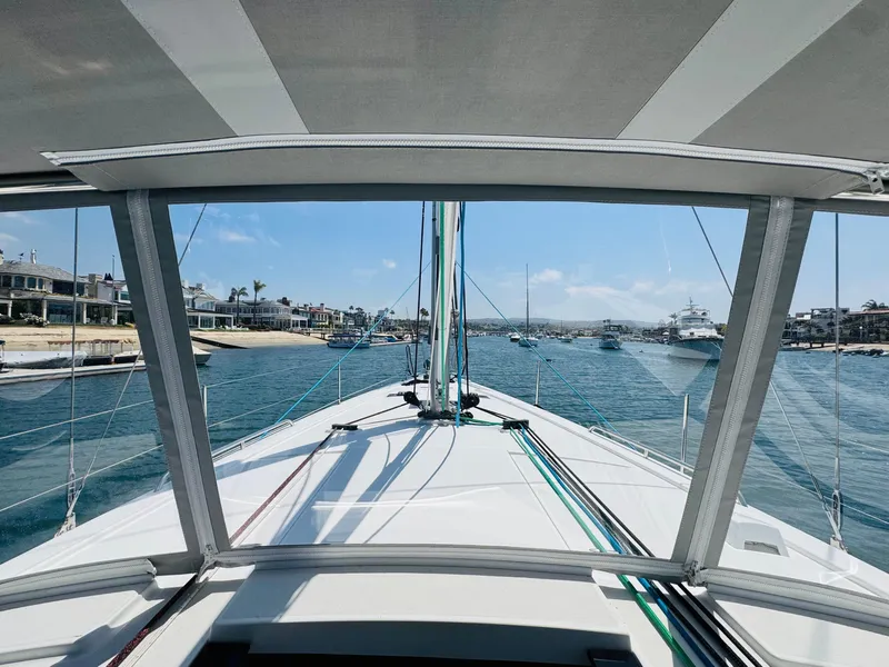 Slide: The Image of Beneteau Oceanis 41.1 sailboat, 2020 model, cruising in a scenic coastal harbor. - 14