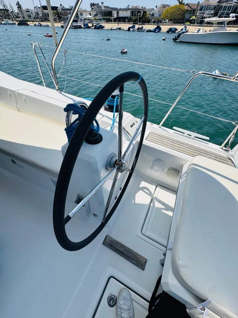 Slide: The Image of Steering wheel of a 2020 Beneteau Oceanis 41.1 sailboat docked by the water. - 18