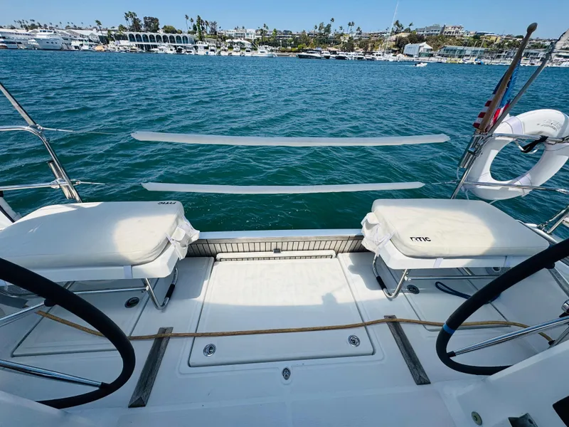 Slide: The Image of Beneteau Oceanis 41.1 sailboat deck, 2020 model, overlooking marina and calm blue waters. - 20