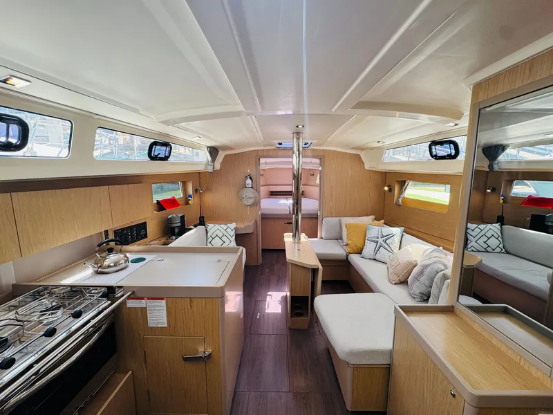 Slide: The Image of Interior of 2020 Beneteau Oceanis 41.1 yacht, featuring modern kitchen and cozy seating area. - 26